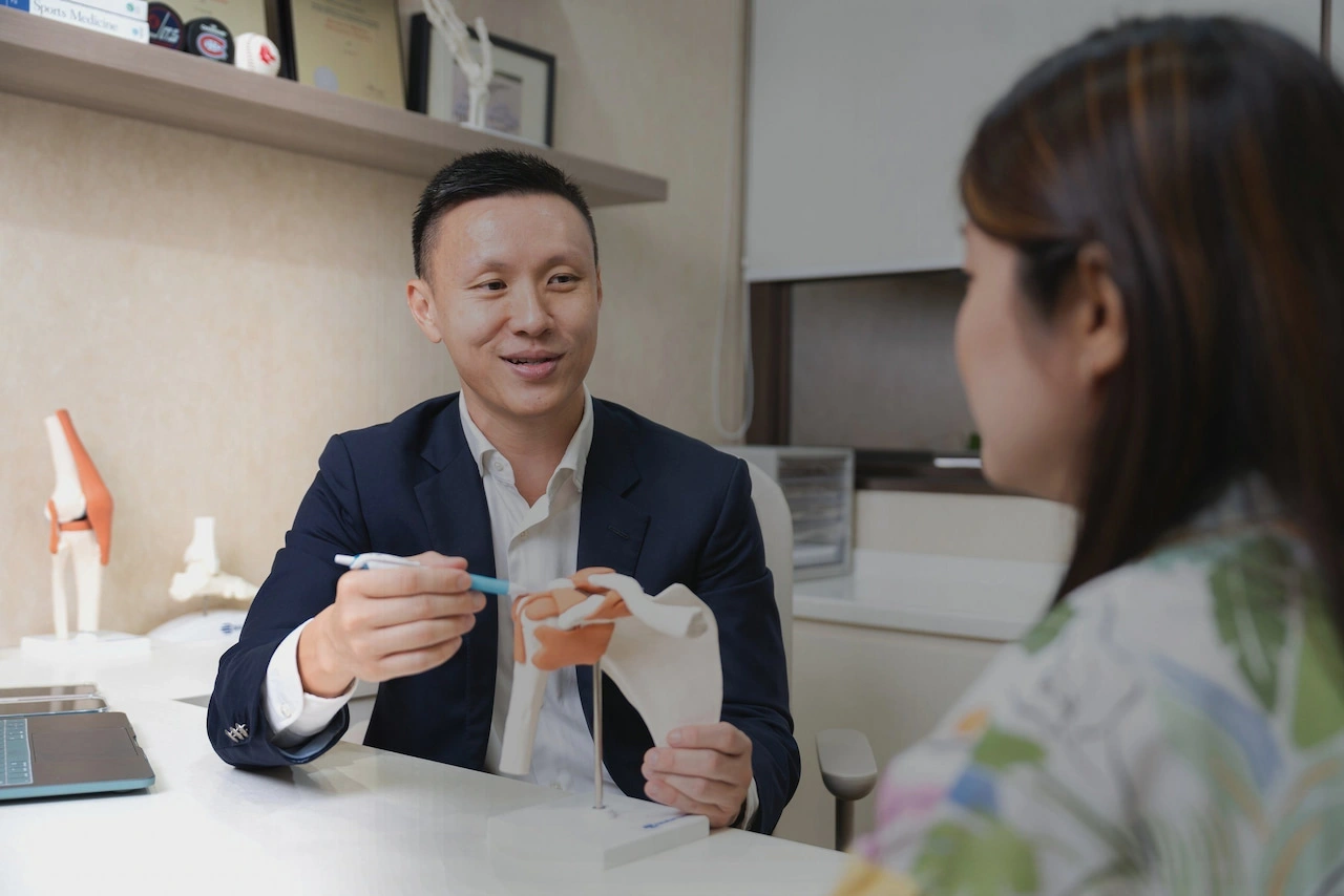 Dr Bryan Wang explaining a diagnosis to a patient